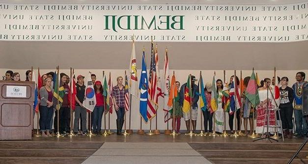 International Students holding flags at Hobson Memorial Union's Ballroom